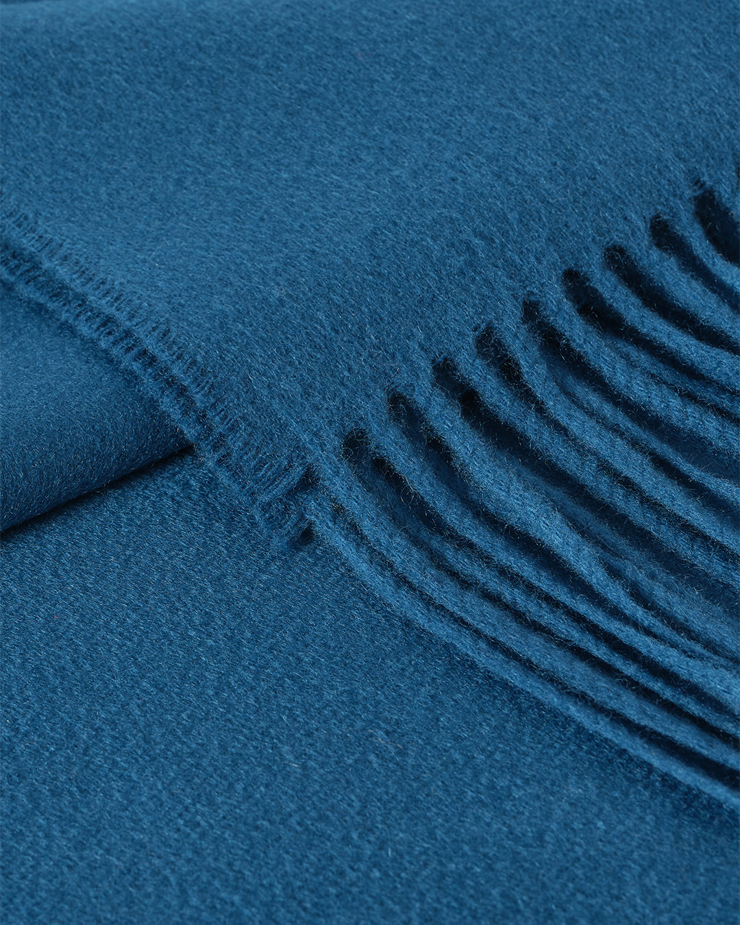 Johnstons of Elgin Plain Cashmere Throw in Petrol – luxury Scottish-woven cashmere throw in a rich petrol blue shade. WA000055SD5123ONE