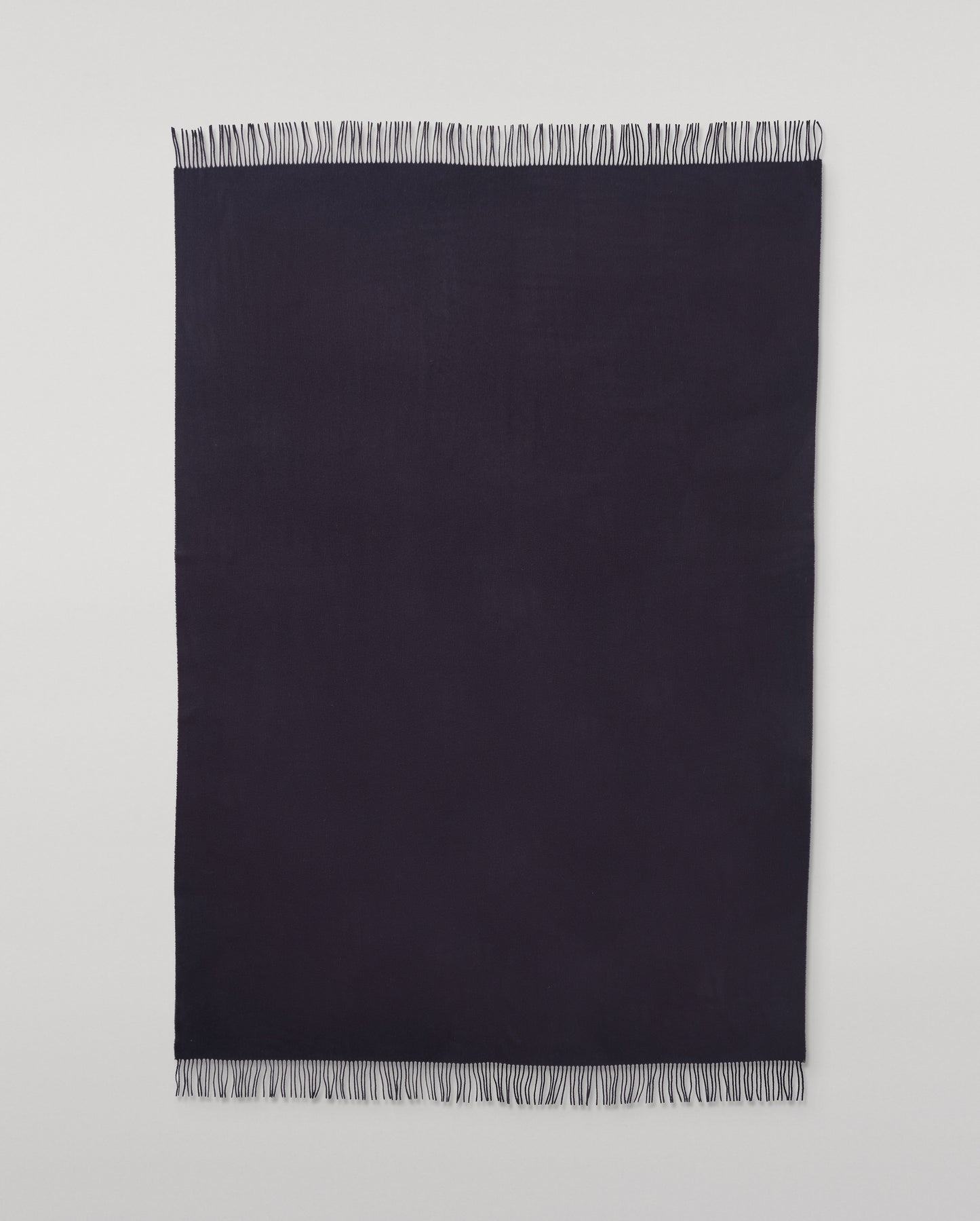 Johnstons of Elgin Interiors Collection  Dark Navy Cashmere Throw on a wooden chair   WA000055SD7330ONE
