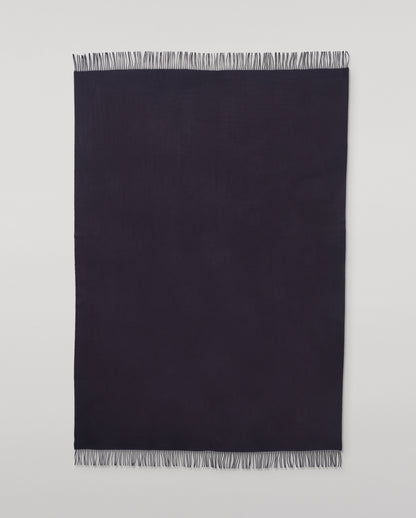 Johnstons of Elgin Interiors Collection  Dark Navy Cashmere Throw on a wooden chair   WA000055SD7330ONE
