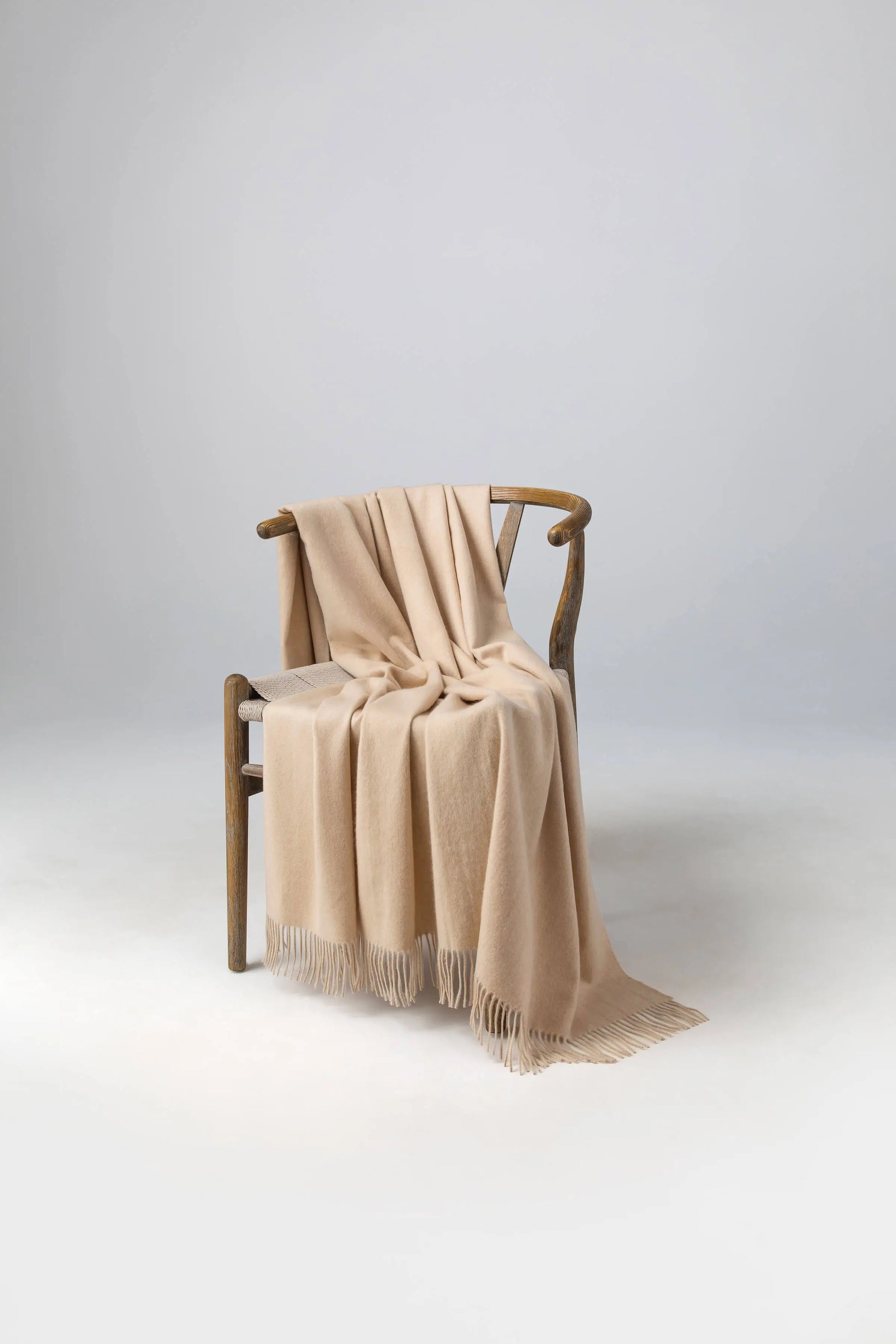 2025 Johnstons of Elgin Interiors Collection Blonde Blonde Cashmere Throw on a wooden chair WA000055HB0167ONE