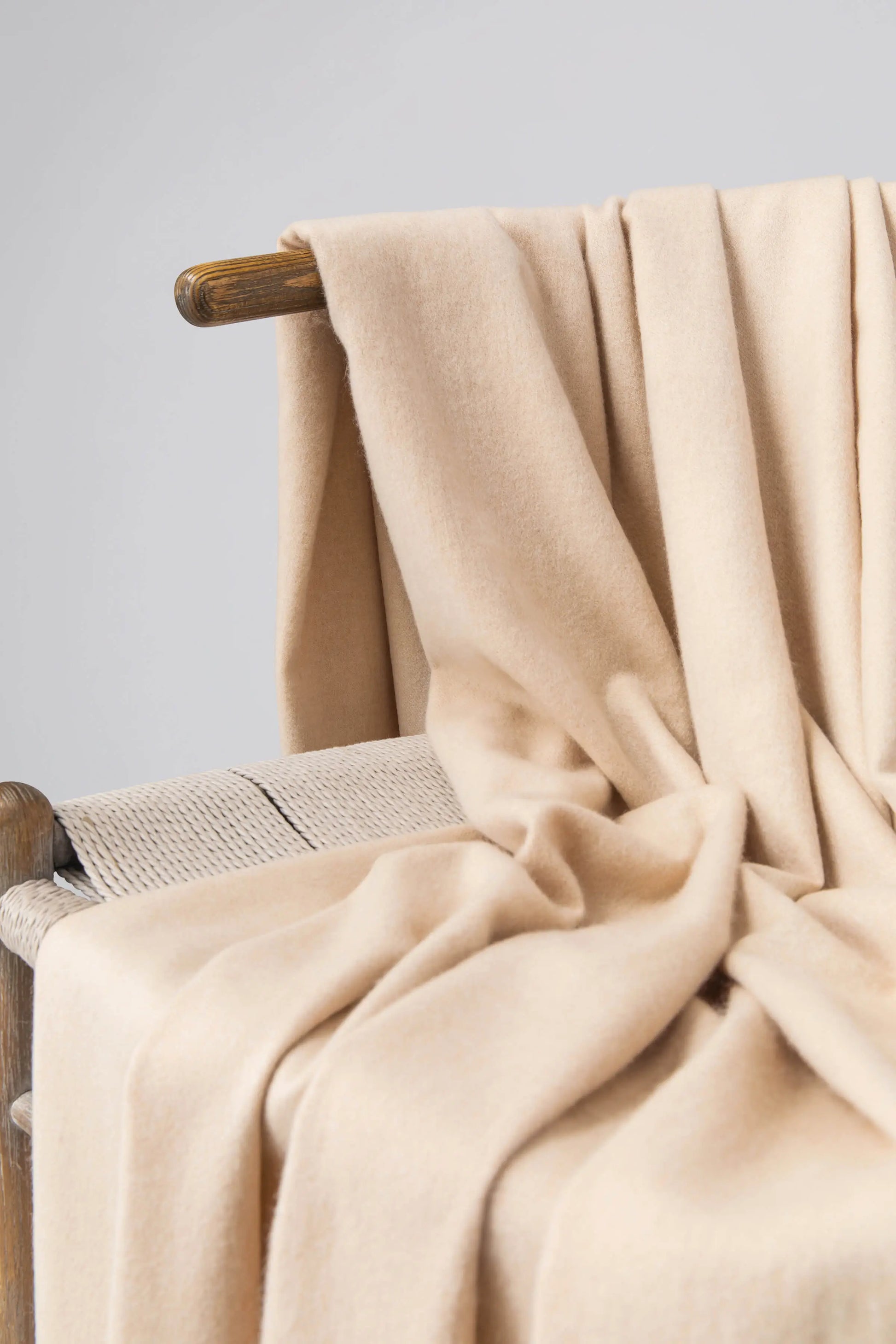 2025 Johnstons of Elgin Interiors Collection Blonde Blonde Cashmere Throw on a wooden chair WA000055HB0167ONE