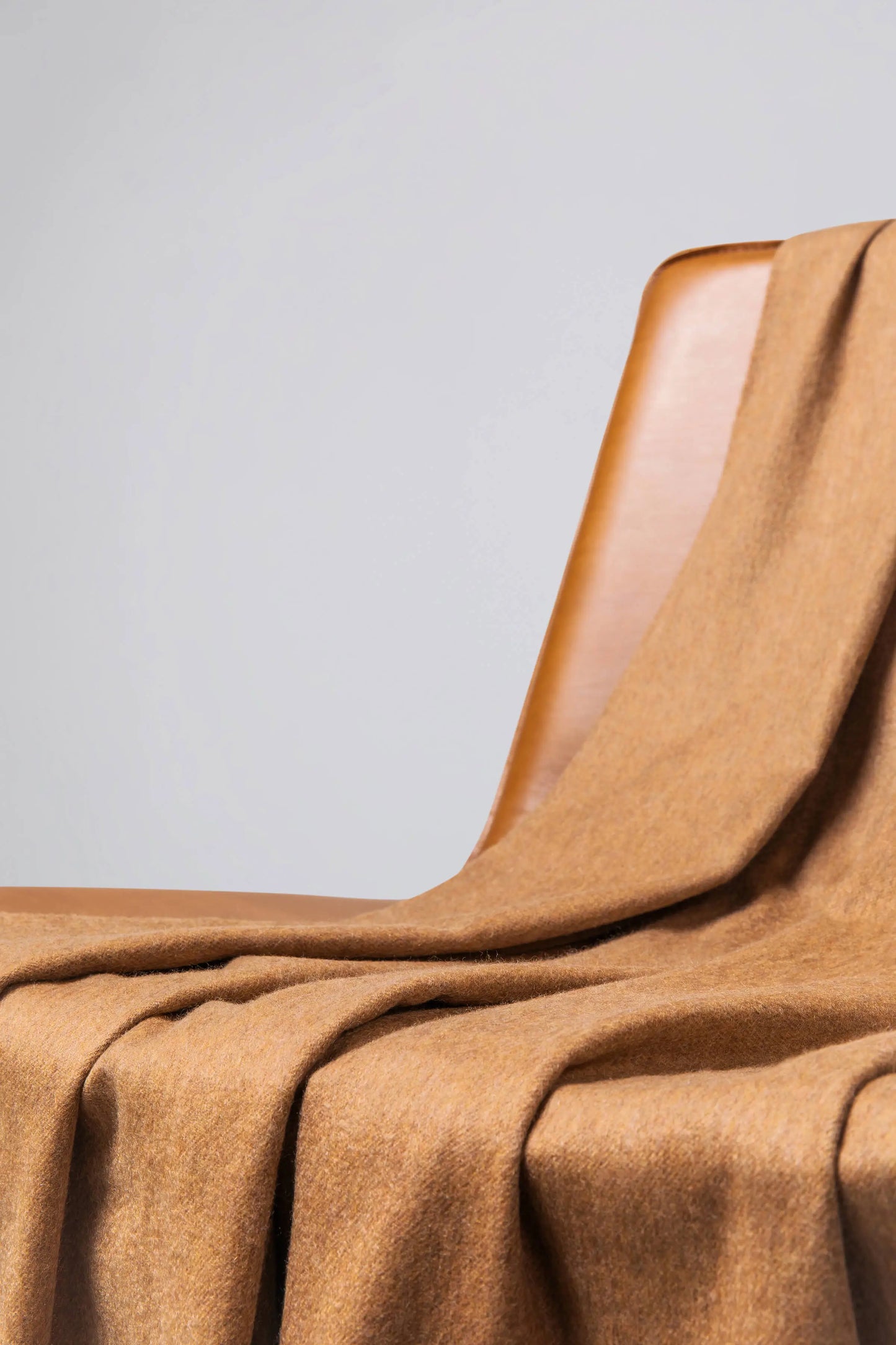 2025 Johnstons of Elgin Interiors Collection Camel Camel Cashmere Throw on a wooden chair WA000055HB4315ONE