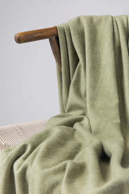 Johnstons of Elgin 2024 Blanket Collection Fern Plain Cashmere Throw on a wooden chair WA000055HC4274ONE