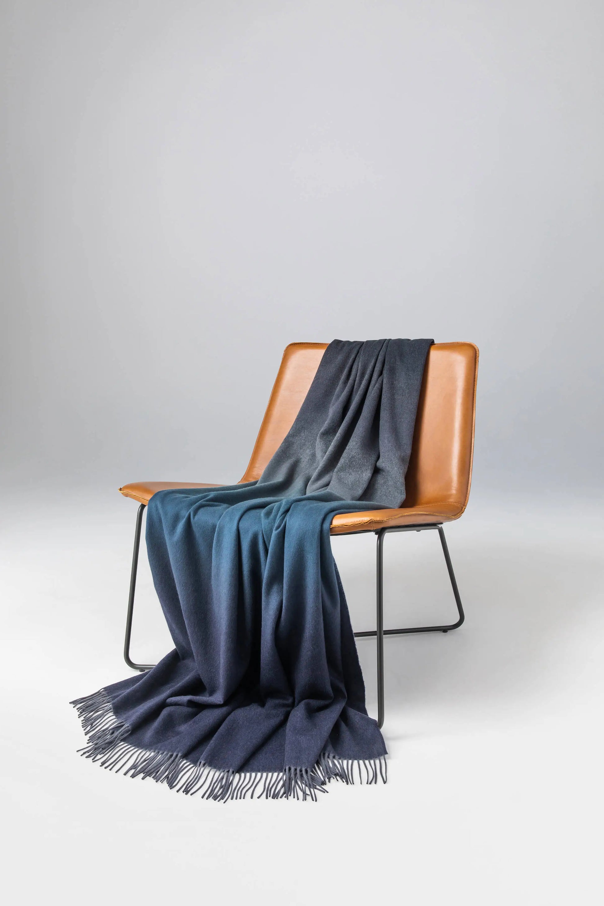 2025 Johnstons of Elgin Interiors Collection Seascape & Navy Ombré Cashmere Throw on a leather chair WA000055RU7686ONE