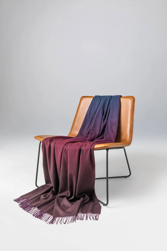 Johnstons of Elgin 2024 Blanket Collection Mallard & Peat Ombré Cashmere Throw on a leather chair  WA000055RU7345ONE