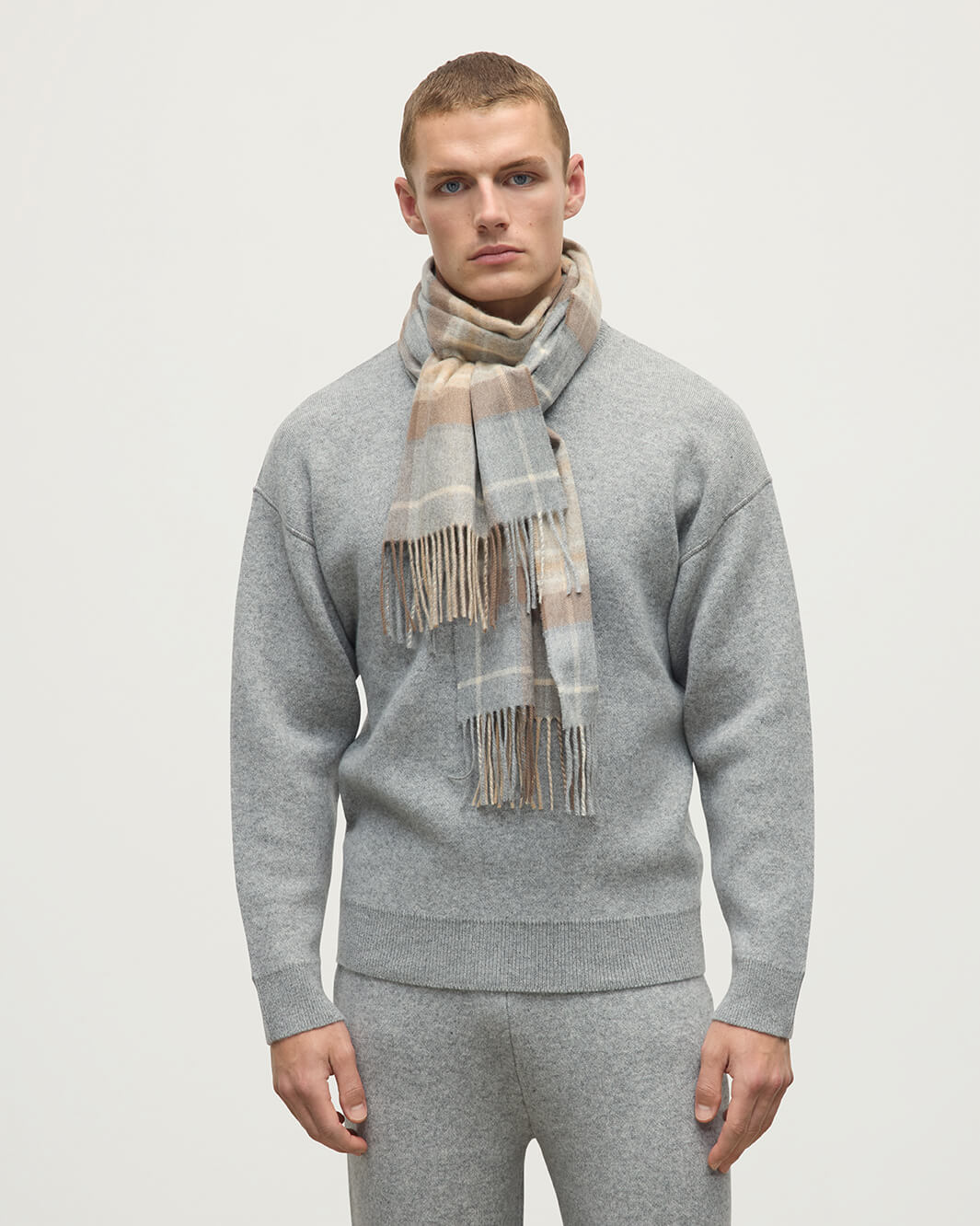 Model wears Johnstons of Elgin AW25 Woven Accessories Natural MacKellar Natural MacKellar Tartan Wide Cashmere Scarf WA000057KU0542ONE