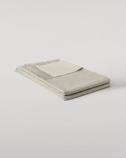 Johnstons of Elgin Interiors Collection Silver & White Reversible Cashmere Bed Throw on a white background  WA001374RU6322ONE