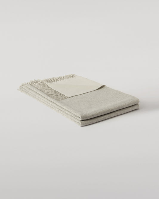 Johnstons of Elgin Interiors Collection Silver & White Reversible Cashmere Bed Throw on a white background  WA001374RU6322ONE