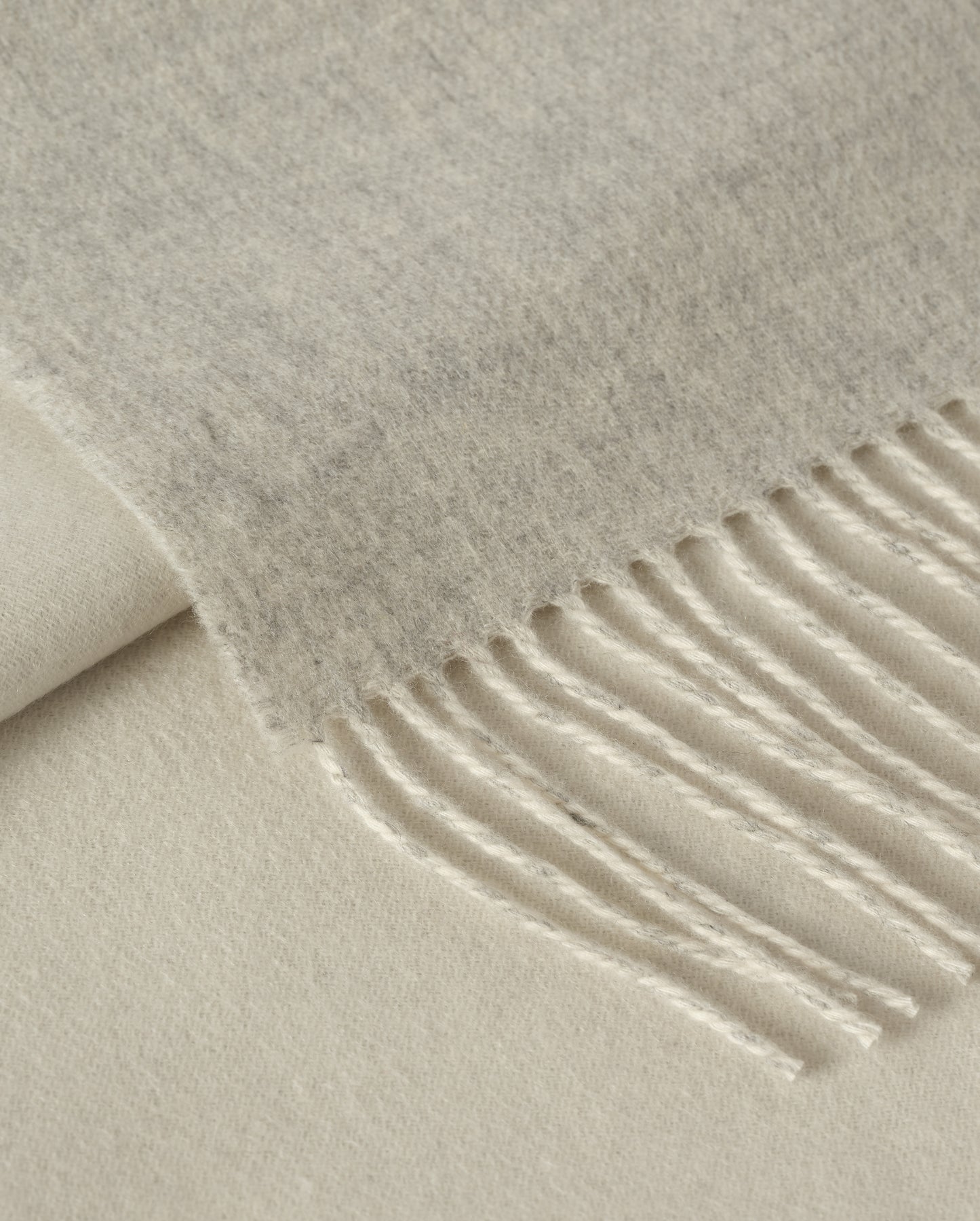 Johnstons of Elgin Interiors Collection Silver & White Reversible Cashmere Bed Throw on a white background  WA001374RU6322ONE