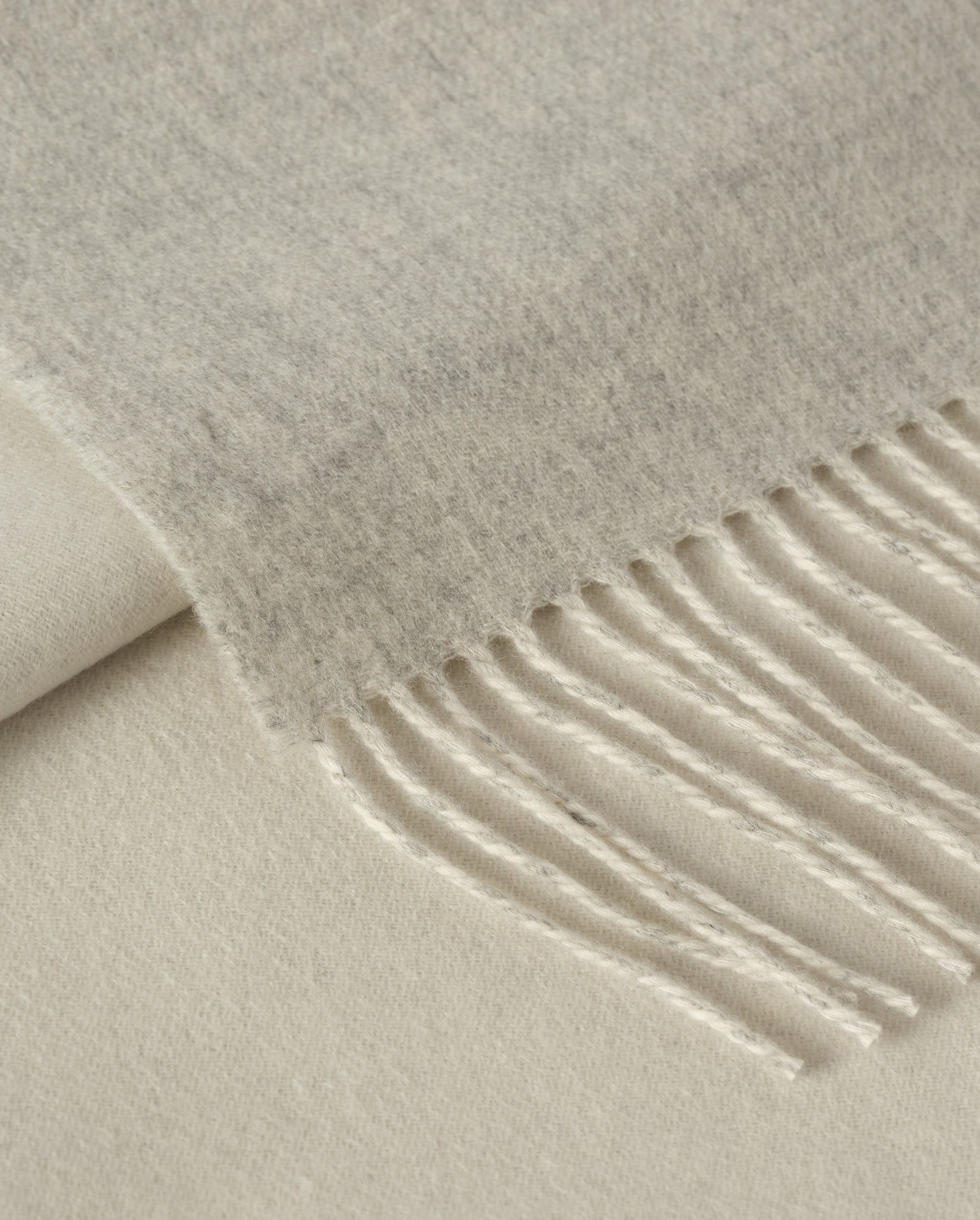 Johnstons of Elgin Interiors Collection Silver & White Reversible Cashmere Bed Throw on a white background  WA001374RU6322ONE