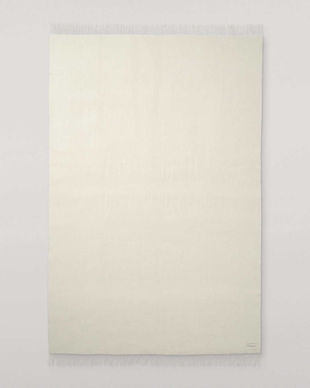 Johnstons of Elgin Interiors Collection Silver & White Reversible Cashmere Bed Throw on a white background  WA001374RU6322ONE