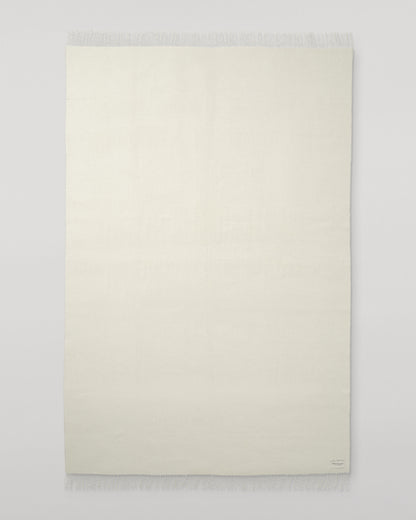 Johnstons of Elgin Interiors Collection Silver & White Reversible Cashmere Bed Throw on a white background  WA001374RU6322ONE