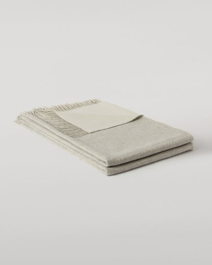 Johnstons of Elgin Interiors Collection Silver & White Reversible Cashmere Bed Throw on a white background  WA001374RU6322ONE