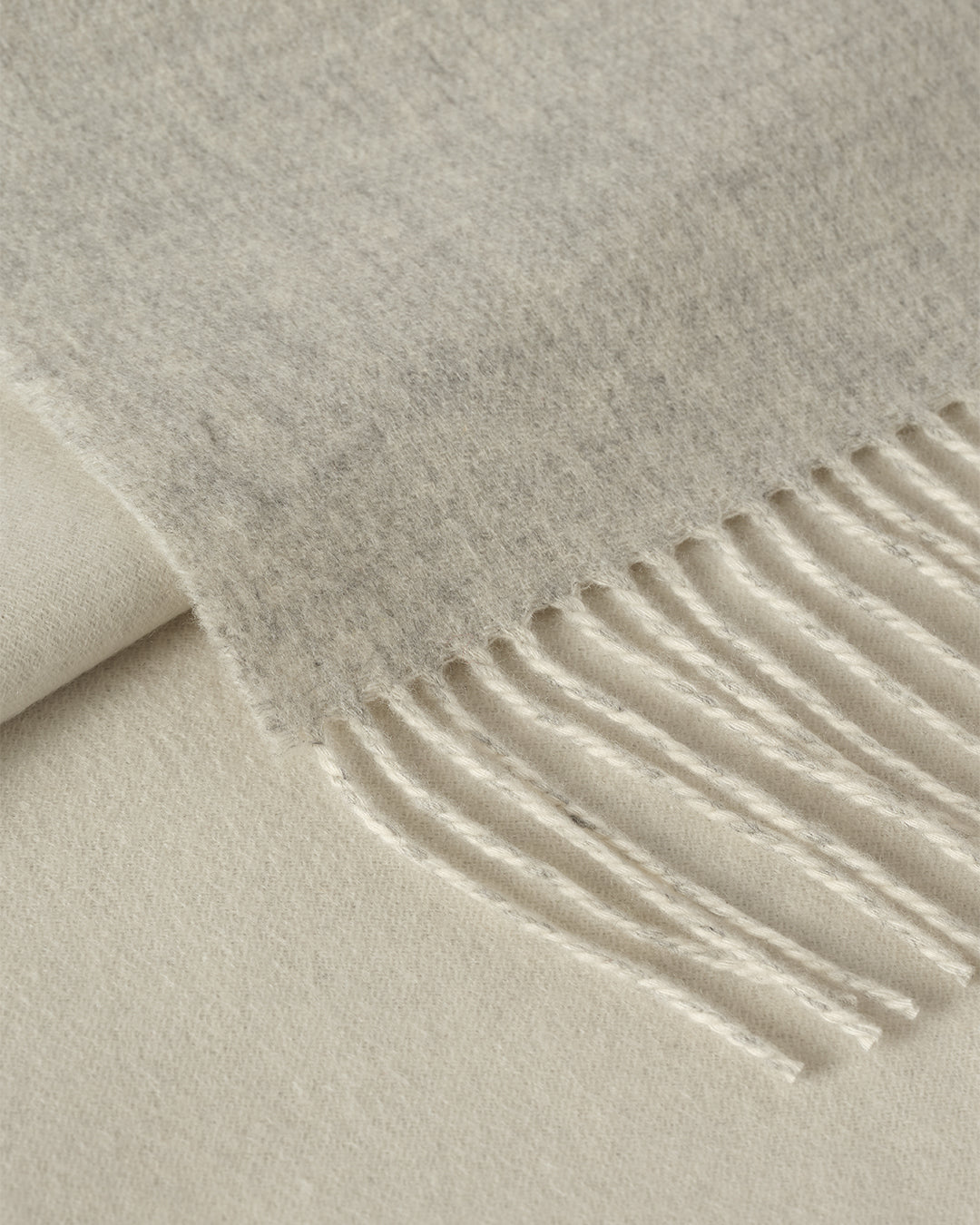 Johnstons of Elgin Interiors Collection Silver & White Reversible Cashmere Bed Throw on a white background  WA001374RU6322ONE