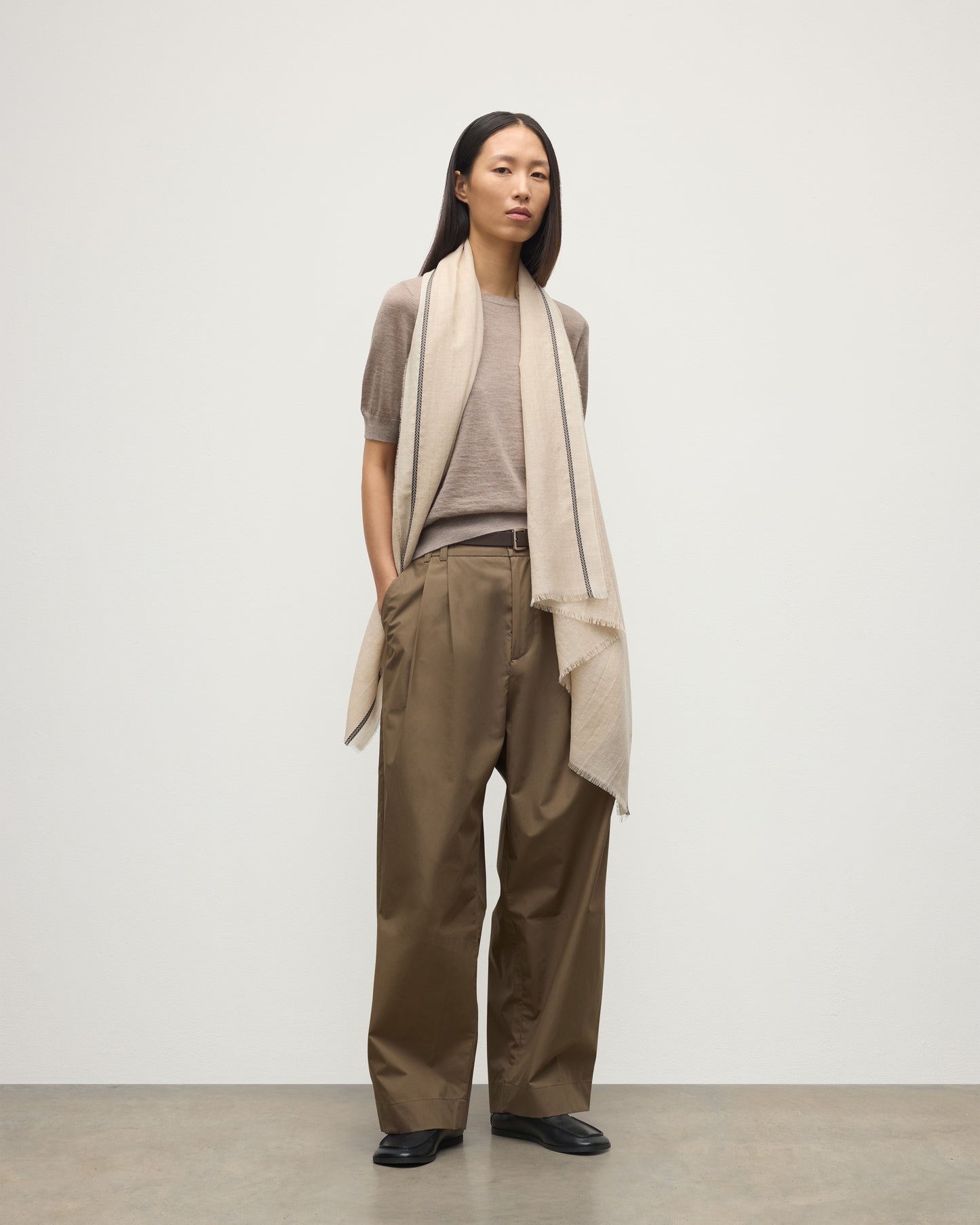 MODEL WEARS JOHNSTONS OF ELGIN IVES CHEVRON BORDER SCARF 100% CASHMERE OVER HONOR LIGHT BROWN T-SHIRT WA002446RU7701ONE