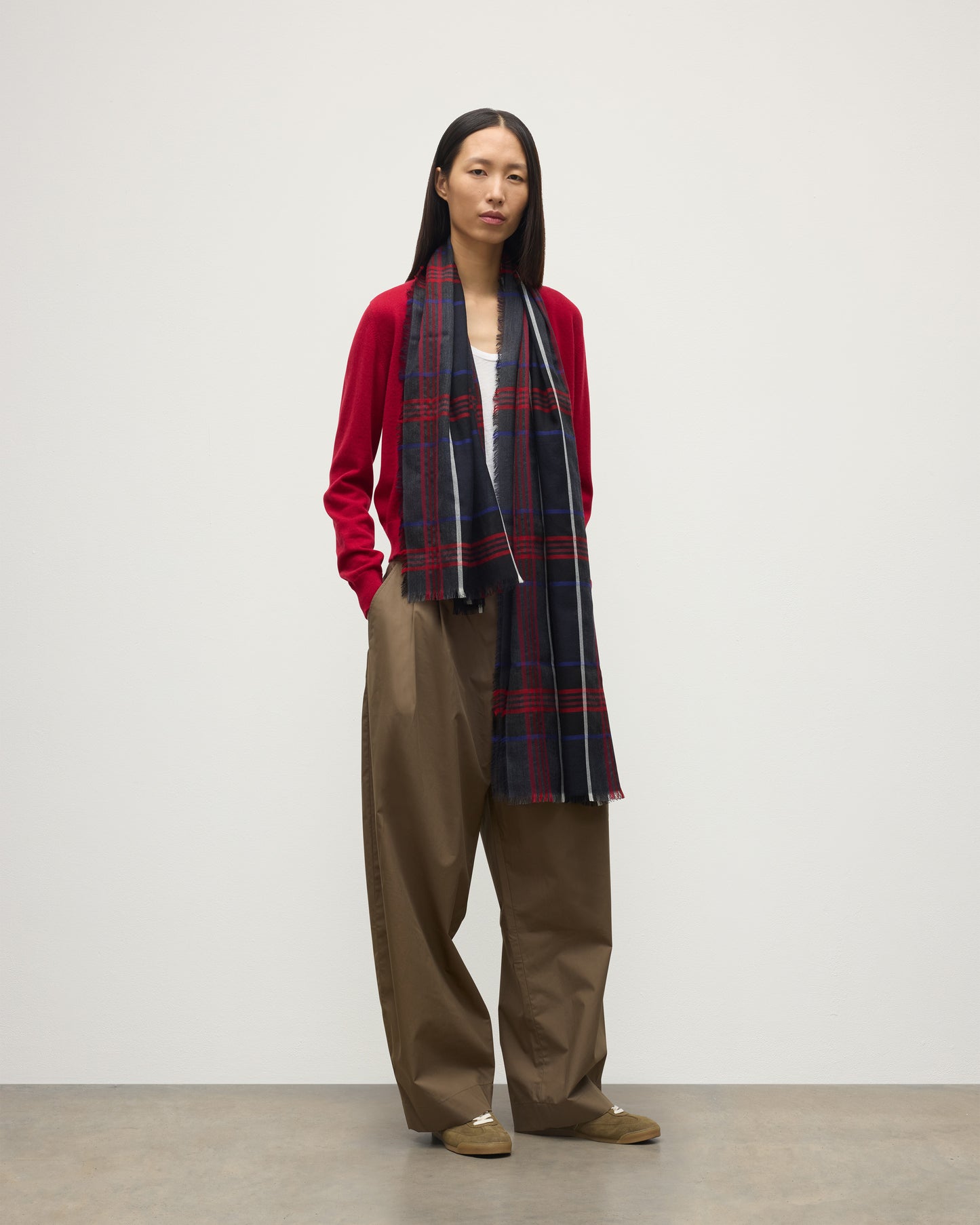 MODEL WEARS JOHNSTONS OF ELGIN ORTON CRAMMED TARTAN SCARF NAVY 100% CASHMERE WOEN OVER CRATHIE RED CASHMERE SHAWL COLLAR CARDI WA002447RU7703ONE