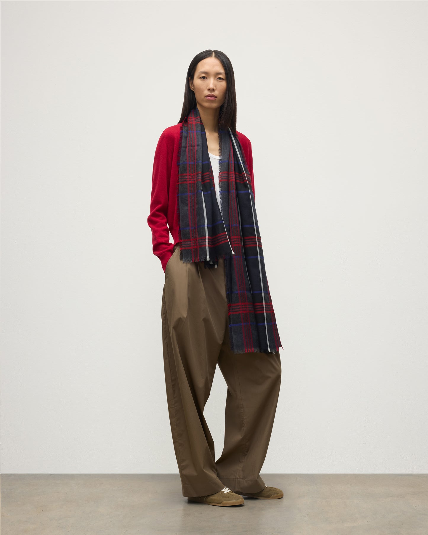 MODEL WEARS JOHNSTONS OF ELGIN ORTON CRAMMED TARTAN SCARF NAVY 100% CASHMERE WOEN OVER CRATHIE RED CASHMERE SHAWL COLLAR CARDI WA002447RU7703ONE