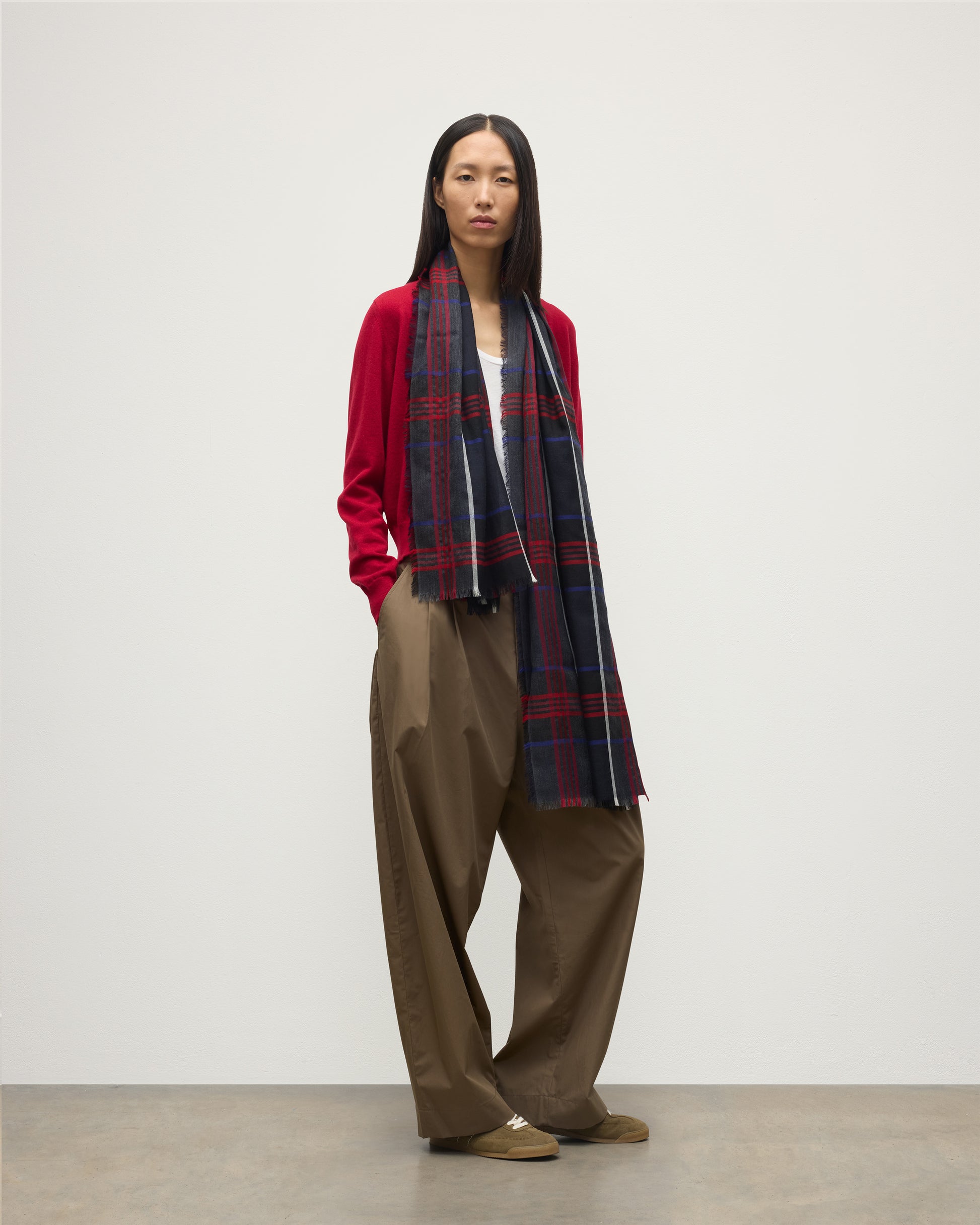 MODEL WEARS JOHNSTONS OF ELGIN ORTON CRAMMED TARTAN SCARF NAVY 100% CASHMERE WOEN OVER CRATHIE RED CASHMERE SHAWL COLLAR CARDI WA002447RU7703ONE