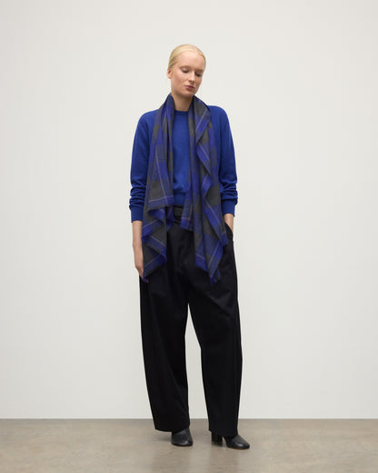 MODEL WEARS JOHNSTONS OF ELGIN CARNBEE LARGE GINGHAM SCARF NAVY 100% CASHMERE OVER RONAY BLUE CASHMERE SWEATER WA002476RU7710ONE