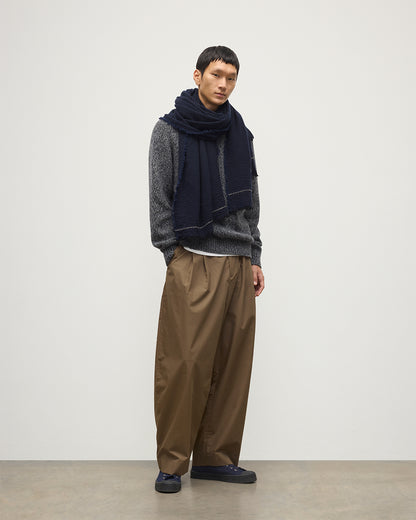 MALE MODEL WEARING JOHNSTONS OF ELGIN USAN SEMI PLAIN SCARF NAVY 100% CASHMERE WITH NAVY MARL CASHMERE SWEATER AND BROWN TROUSERS WA002550RU7720ONE