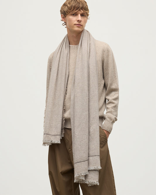 MALE MODEL WEARS JOHNSTONS OF ELGIN USAN SEMI PLAIN SCARF NATURAL 100% CASHMERE OVER A NATURAL CASHMERE SWEATER WA002550RU7719ONE