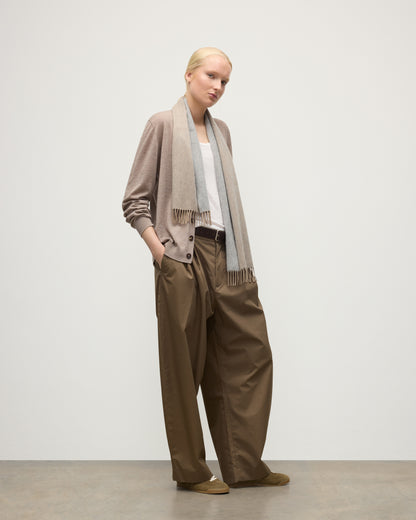 FEMALE MODEL WEARS JOHNSTONS OF ELGIN NATURAL BARD SCARF 100% CASHMERE OVER A LIOGHT BROWN CASHMERE CARDIGAN AND WHITE VEST WA002560RU7726ONE