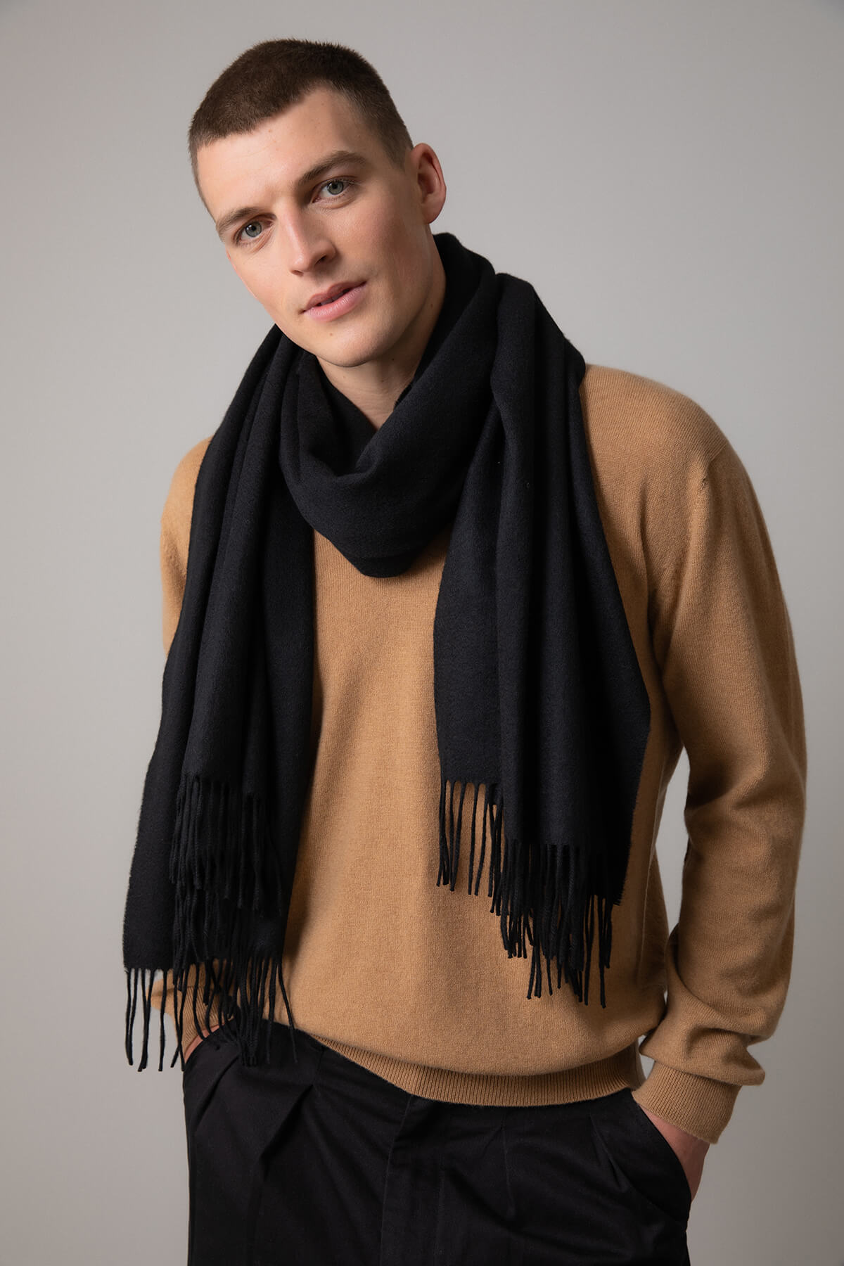 Model wearing Johnstons of Elgin 100% Cashmere Stole in Black on a grey background WA000056SA0900N/A
