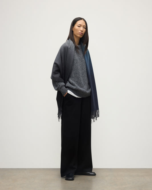 FEMALE MODEL WEARING JOHNSTONS OF ELGIN UMBRA OMBRE STOLE BLACK & NAVY 100% CASHMERE OVER BLACK & FYFE NAVY MARL CASHMERE KNITWEAR WA000056RU7302ONE