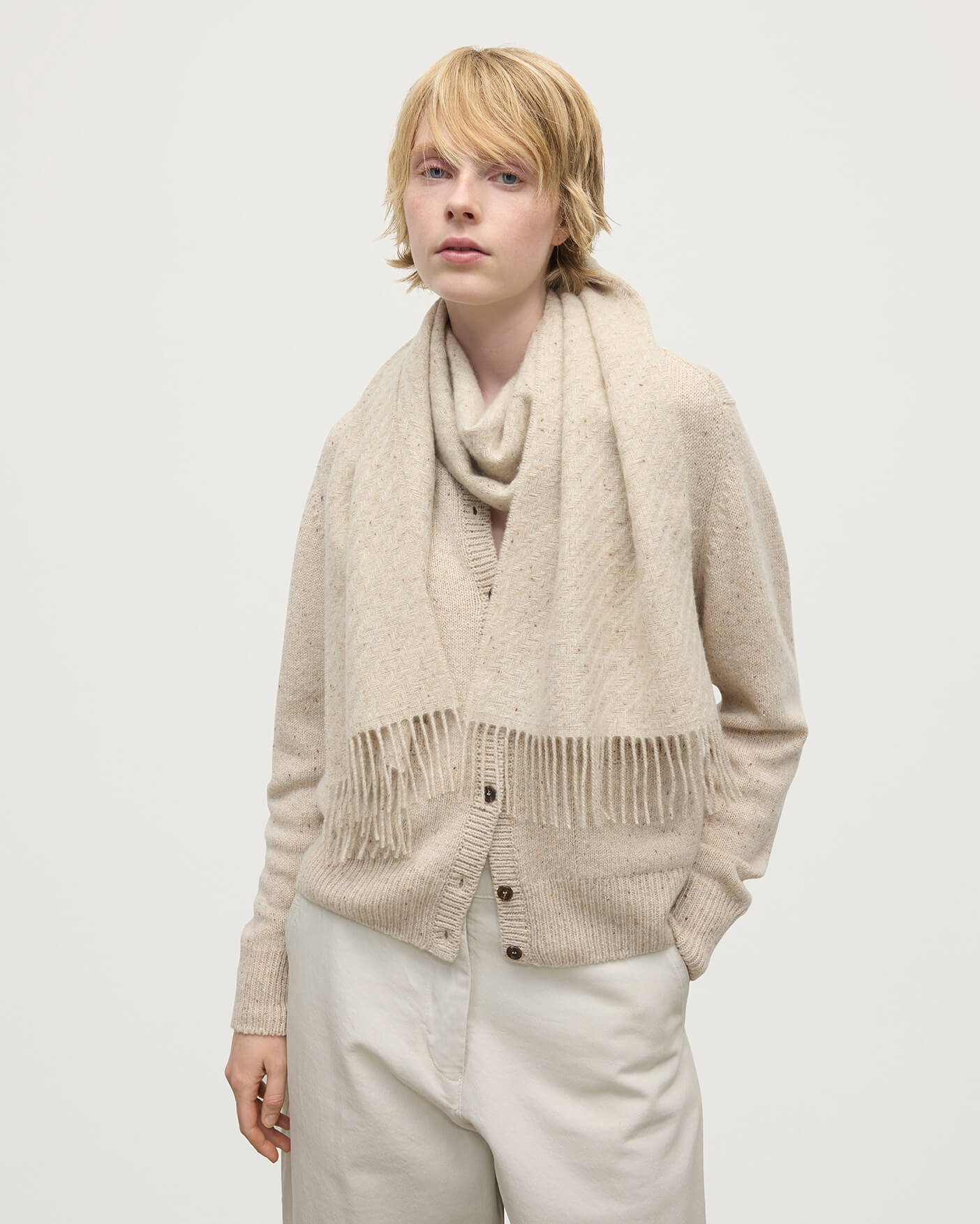 Model wearing Johnstons of Elgin  Woven Accessories Cream Dun Lofty Twill Cream Cashmere Scarf WAC02307RU7658ONE