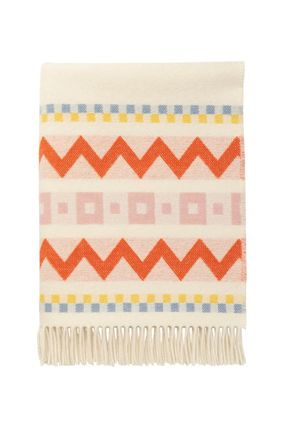 Folded Johnstons of Elgin Children's Zig Zag Blanket in shades of pink, orange, and cream on a white back ground. WB002334RU7277ONE