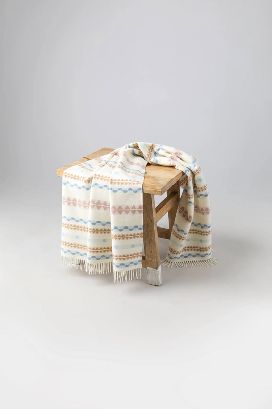 2025 Johnstons of Elgin Interiors Collection Soft Purled Fringe Children's Blanket on a wooden stool WB002334RU7438ONE