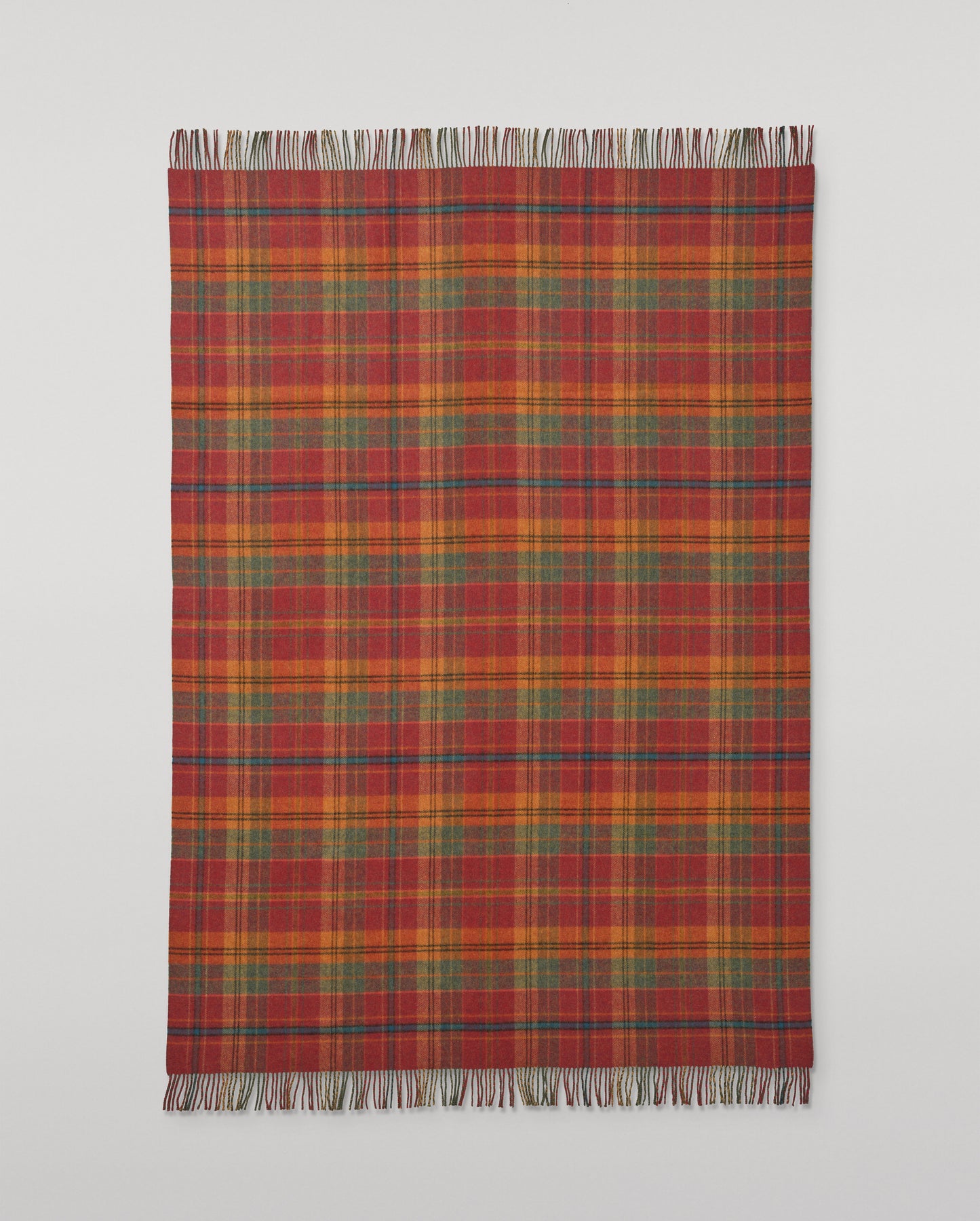 Johnstons of Elgin Interiors Collection Red Tweed & Green Windowpane Reversible Lambswool Throw on a grey background  WD000021XU0036N/A