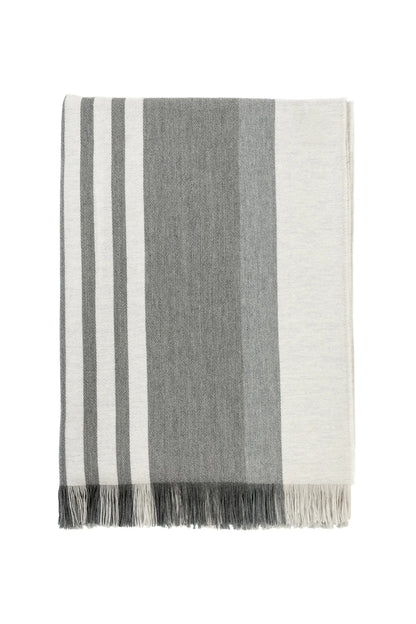 Johnstons of Elgin’s Bold Stripe Grey Merino Throw on brown chair on a white background WD000257RU6994ONE