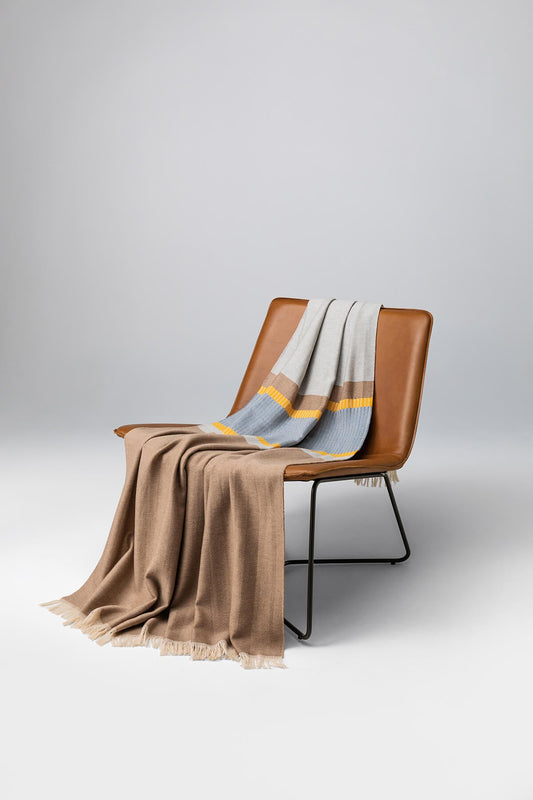 Johnstons of Elgin Bold Stripe Merino Blend Throw in Yellow on a leather chair WD000257RU7287ONE