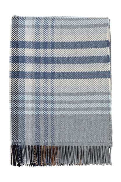 Johnstons of Elgin’s Blue & Grey Lofty Check Merino Throw on brown chair on a grey background WD001221RU6979ONE