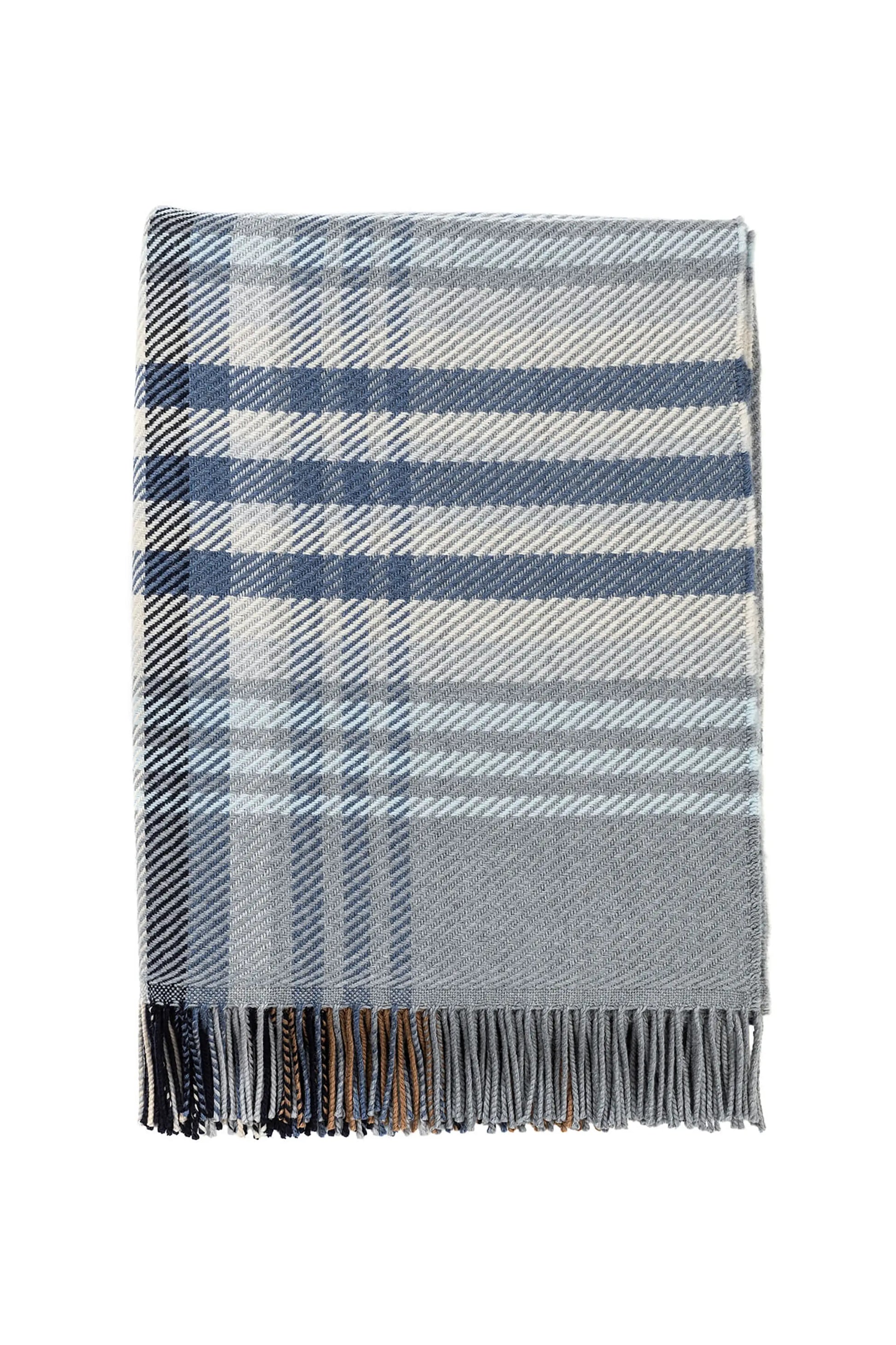 Johnstons of Elgin’s Blue & Grey Lofty Check Merino Throw on brown chair on a grey background WD001221RU6979ONE