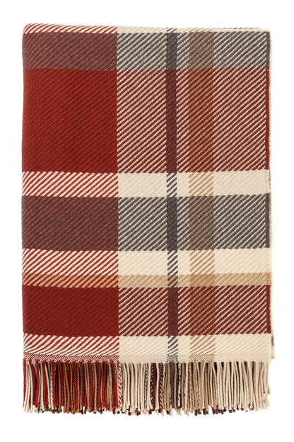 Johnstons of Elgin’s Auburn Red Lofty Check Merino Throw on brown chair on a grey background WD001221RU6981ONE