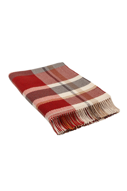 Johnstons of Elgin’s Auburn Red Lofty Check Merino Throw on brown chair on a grey background WD001221RU6981ONE