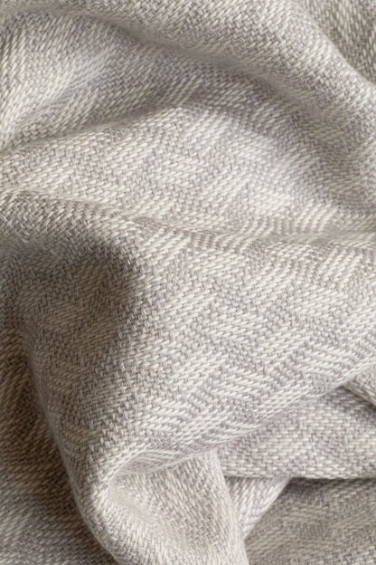 Johnstons of Elgin’s Lattice Weave Merino Bed Throw in Silver & White on bed in neutral bedroom WD001243RU7269ONE