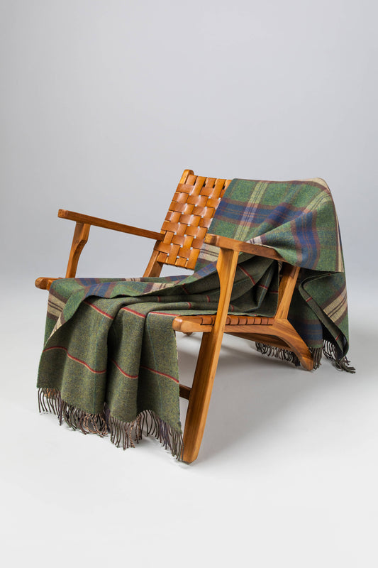 Johnstons of Elgin’s Scottish Heritage Double Face Forth Check Lambswool Throw on brown chair on a grey background WD000021XU0287N/A