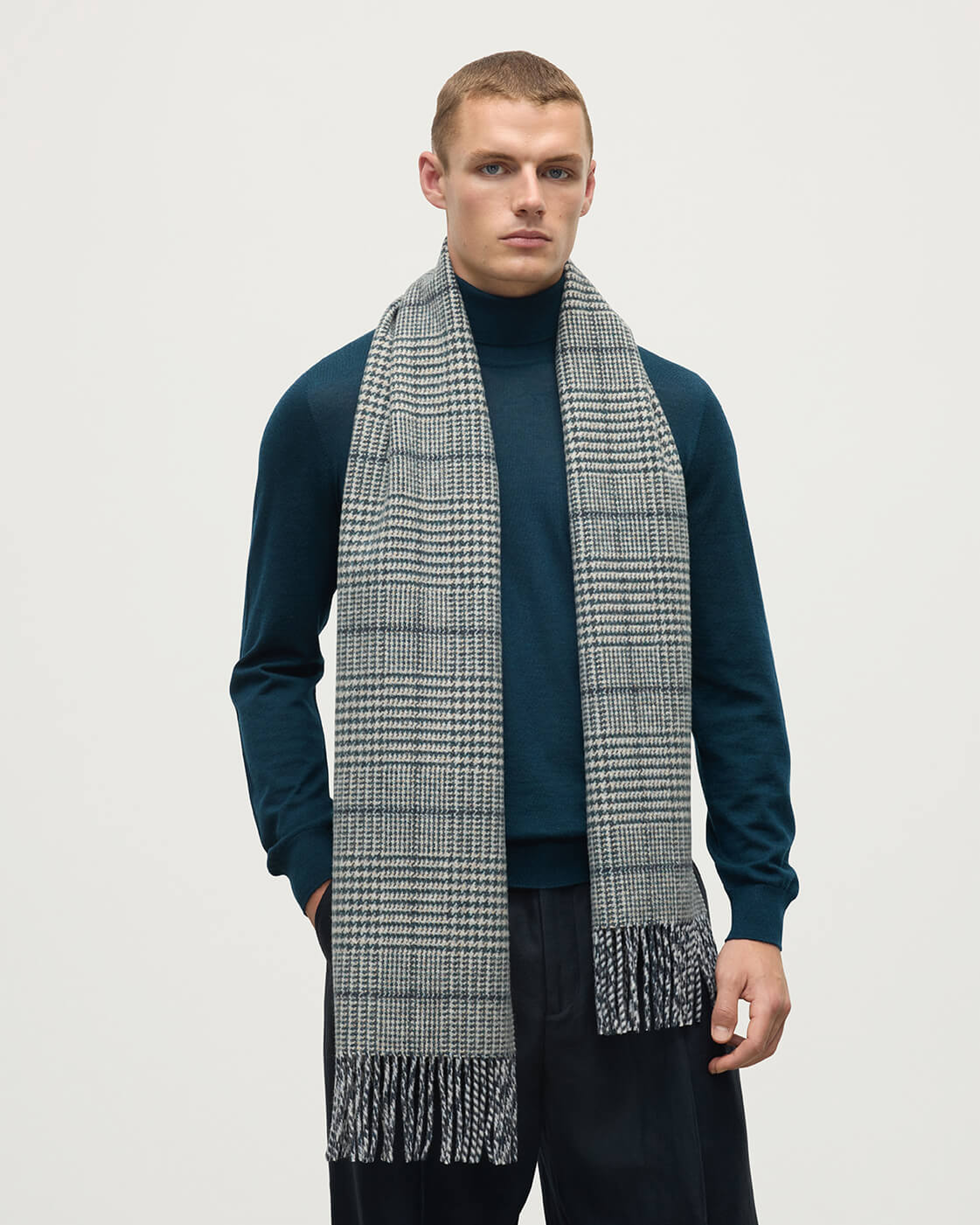 Model wearing Johnstons of Elgin Bottle Green Tweed Scarf WDC01923RU7652ONE